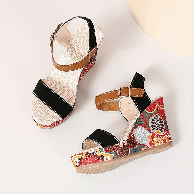 Women's floral embroidered wedge sandals in black, green, and orange with buckle strap