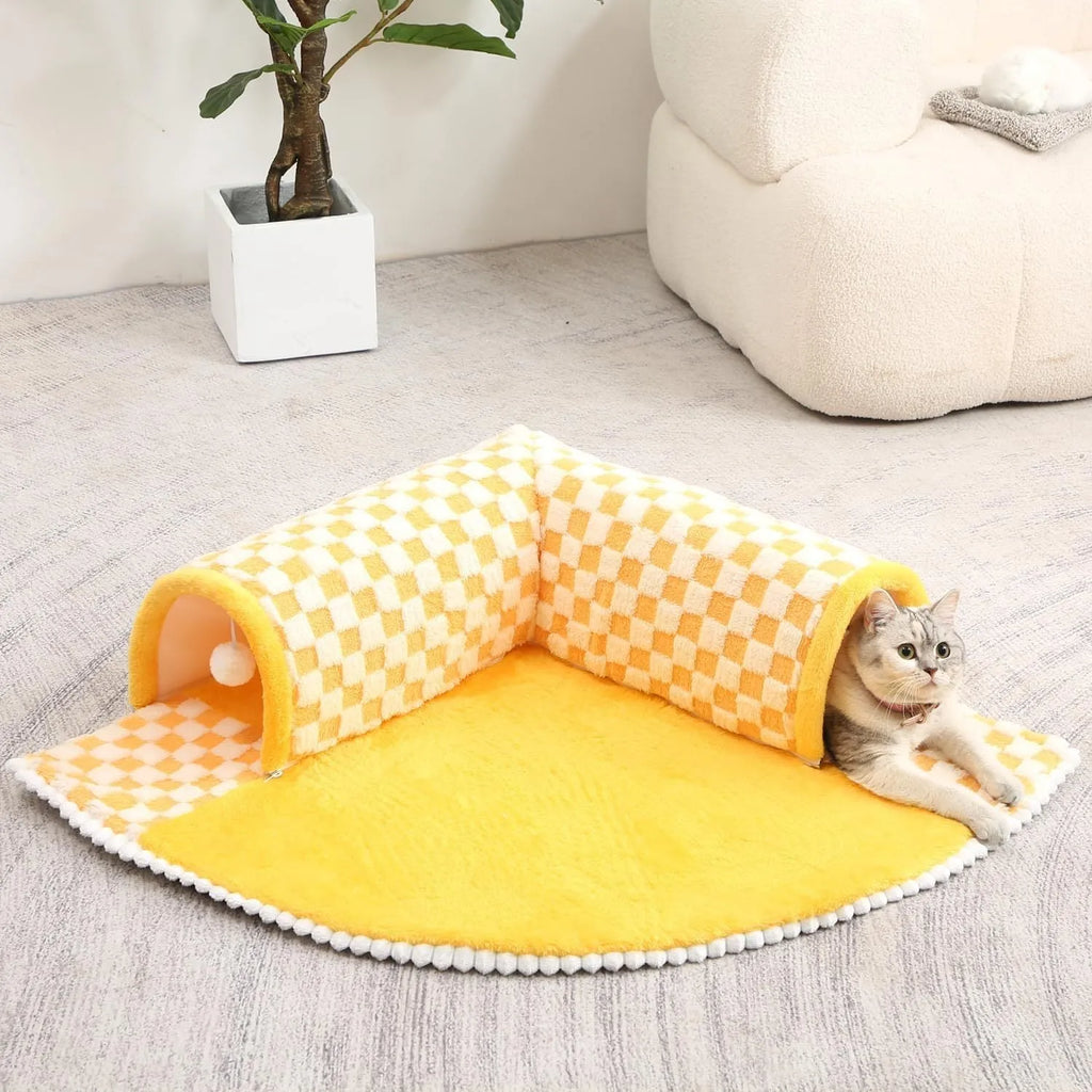 Large plush fan-shaped dog and cat bed with central tunnel, in coffee colour, on a floor.