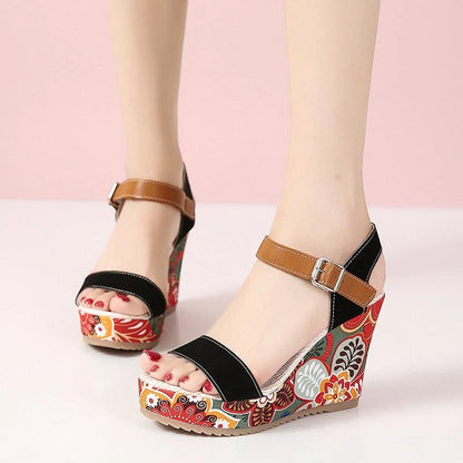Women's floral embroidered wedge sandals in black, green, and orange with buckle strap