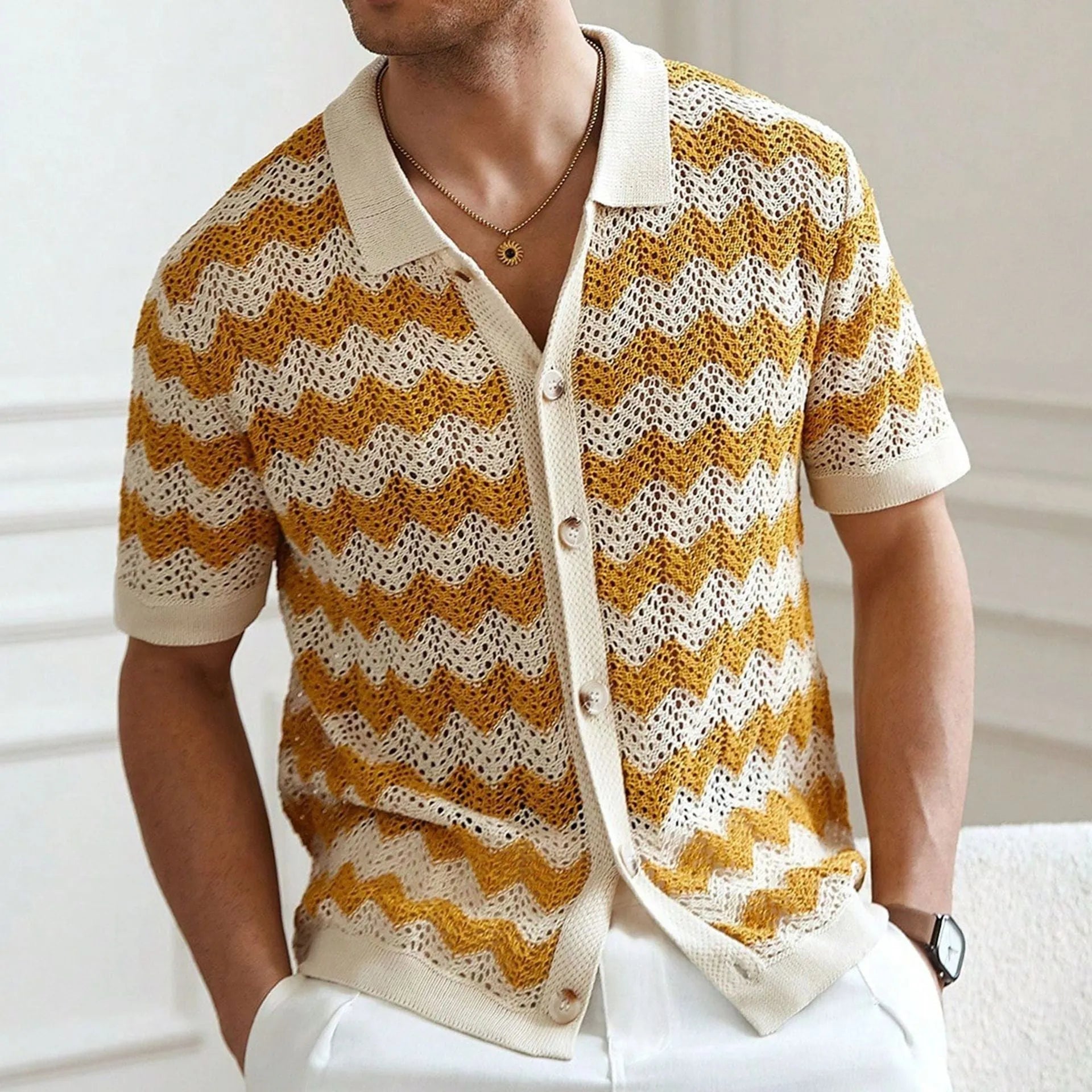 A yellow short-sleeve sweater with a textured corrugated jacquard pattern and a flocked surface detail.