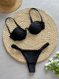 Women's black underwire bikini top and briefs set made from high elasticity nylon fabric.