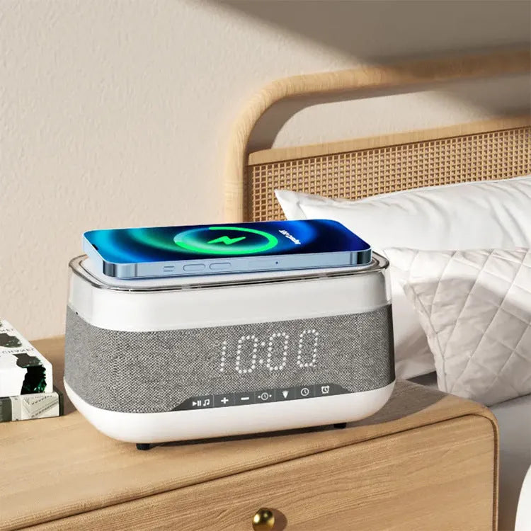 White multifunctional alarm clock with Bluetooth speaker and wireless charging pad for mobile phones