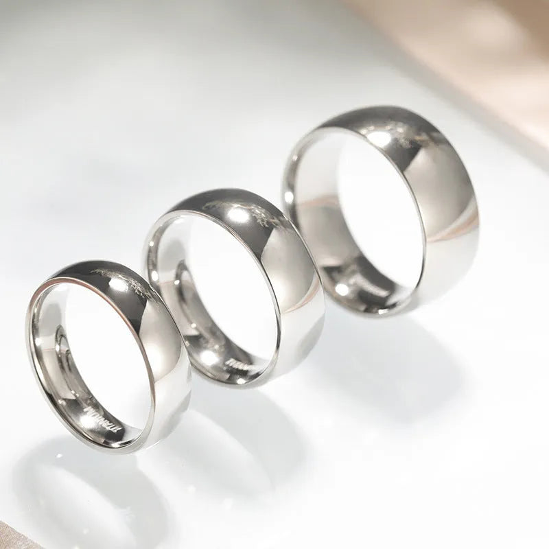 Simple silver titanium steel ring shown in various widths on a size chart.