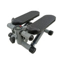 Silver grey hydraulic mini treadmill for waist slimming exercises in a home setting.