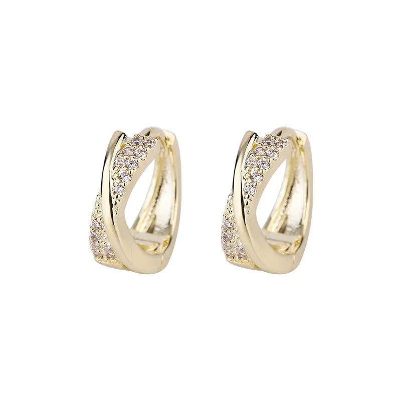 A pair of geometric earrings in 14K yellow colour, made from copper with a zircon treatment.