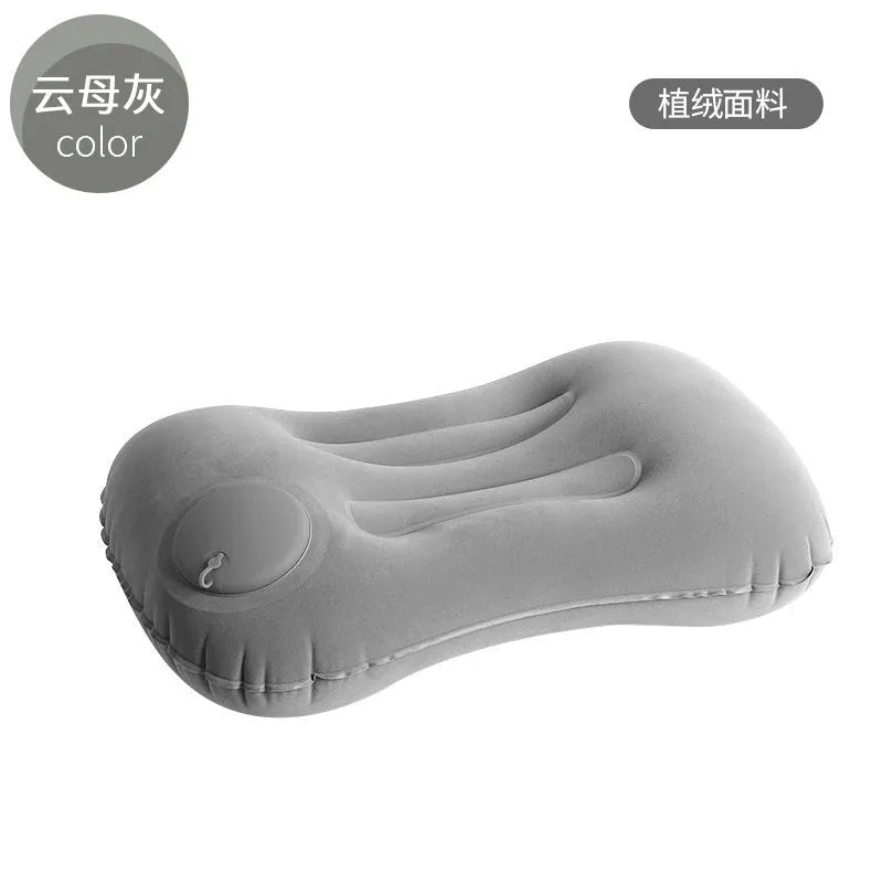 Grey flocking finish portable press inflatable travel pillow for neck support, shown deflated and inflated.