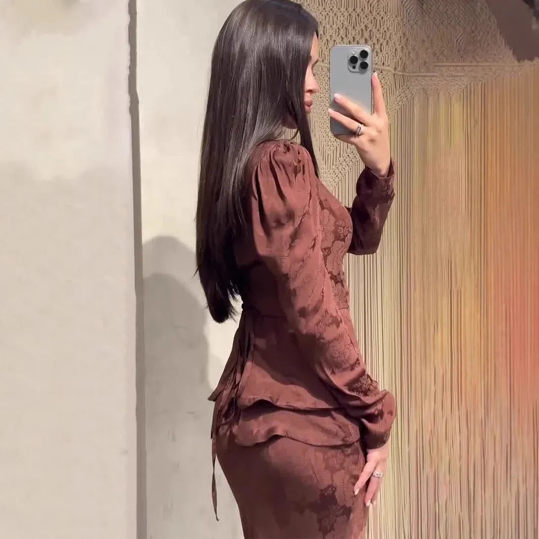 Dark brown long sleeve women's dress with floral pattern and button details on a fake two-piece design.