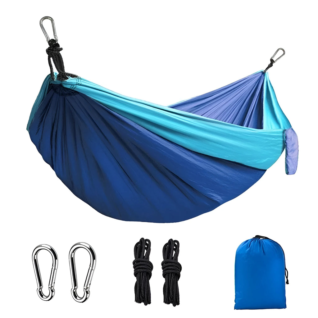 Blue nylon parachute cloth outdoor camping hammock hung between trees
