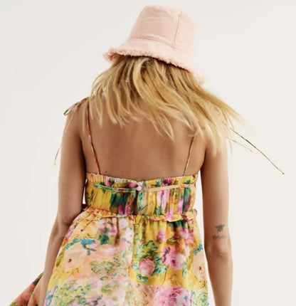 Stylish floral suspender dress with adjustable straps and playful ruffles, perfect for summer fun and fashion