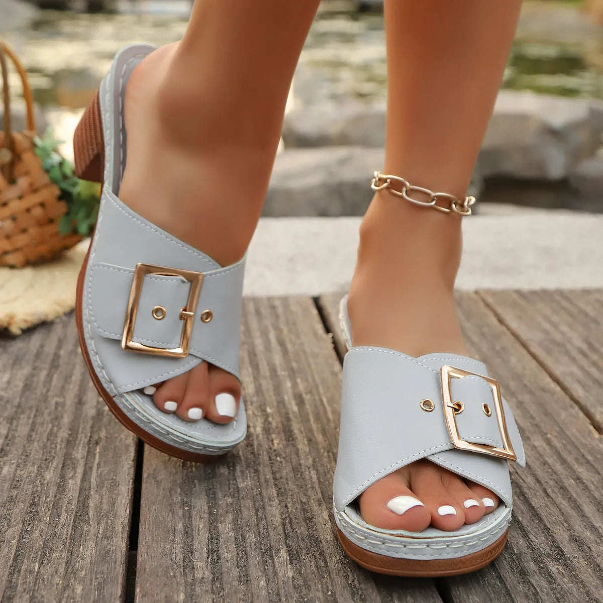 Women's black retro chunky heel slippers with a silver metal buckle on the strap.