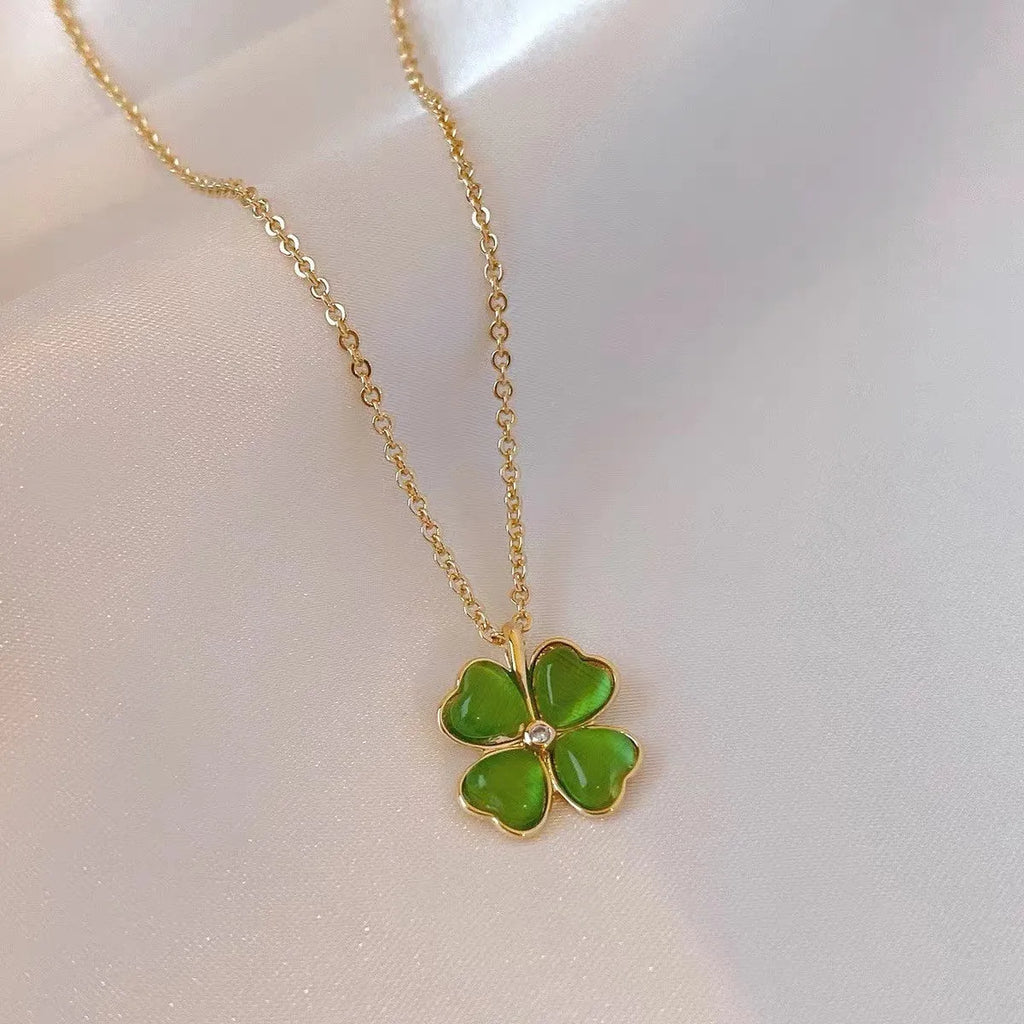 Titanium steel golden clavicle chain with geometric four-leaf flower design on unisex display
