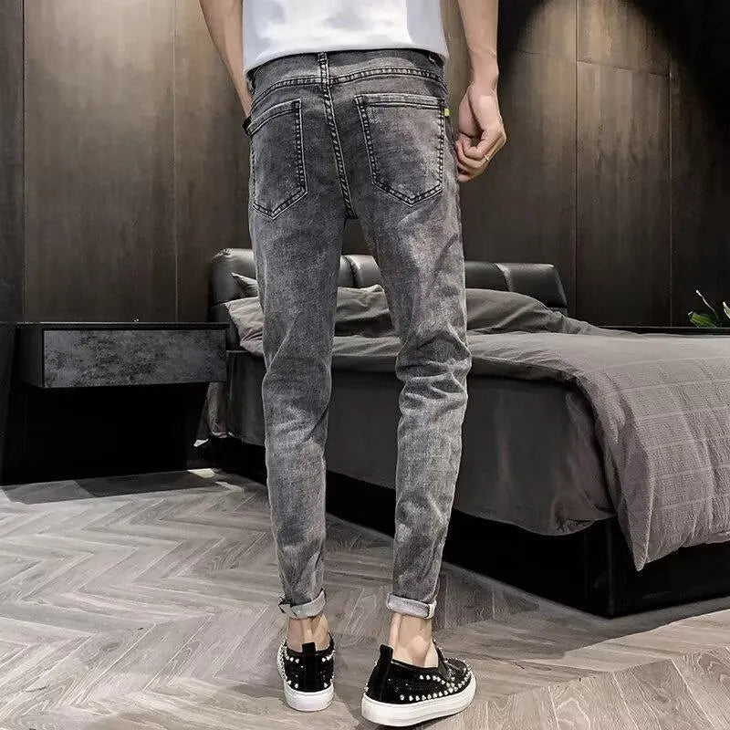 Men's high-waisted denim jeans in casual style with button fly and elastic fabric