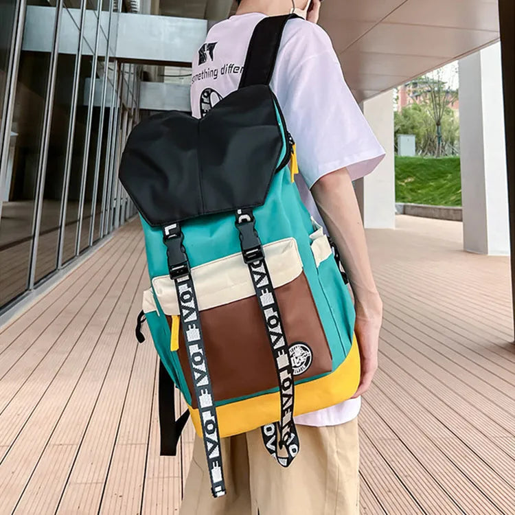 Black oxford cloth backpack with adjustable straps, shown next to green and red colour options.