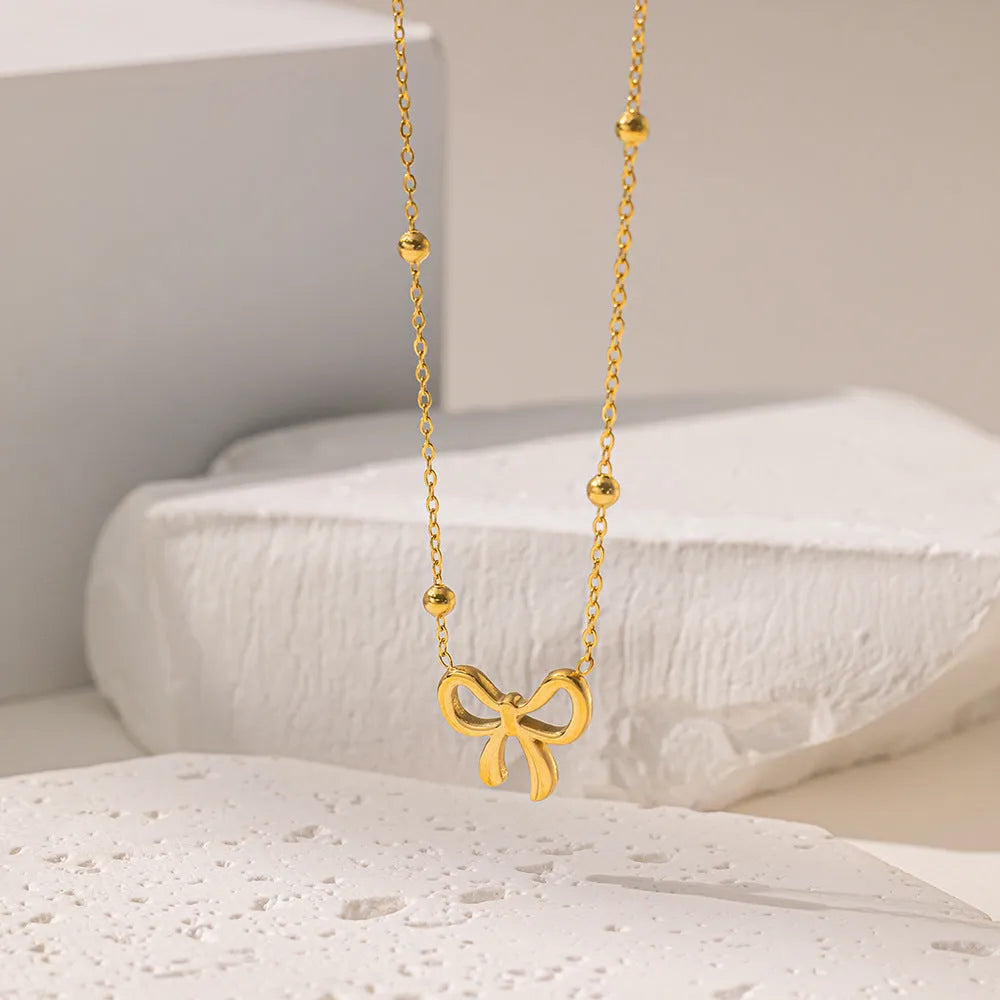 Gold bow necklace with titanium steel cross chain, adjustable length 41-50cm