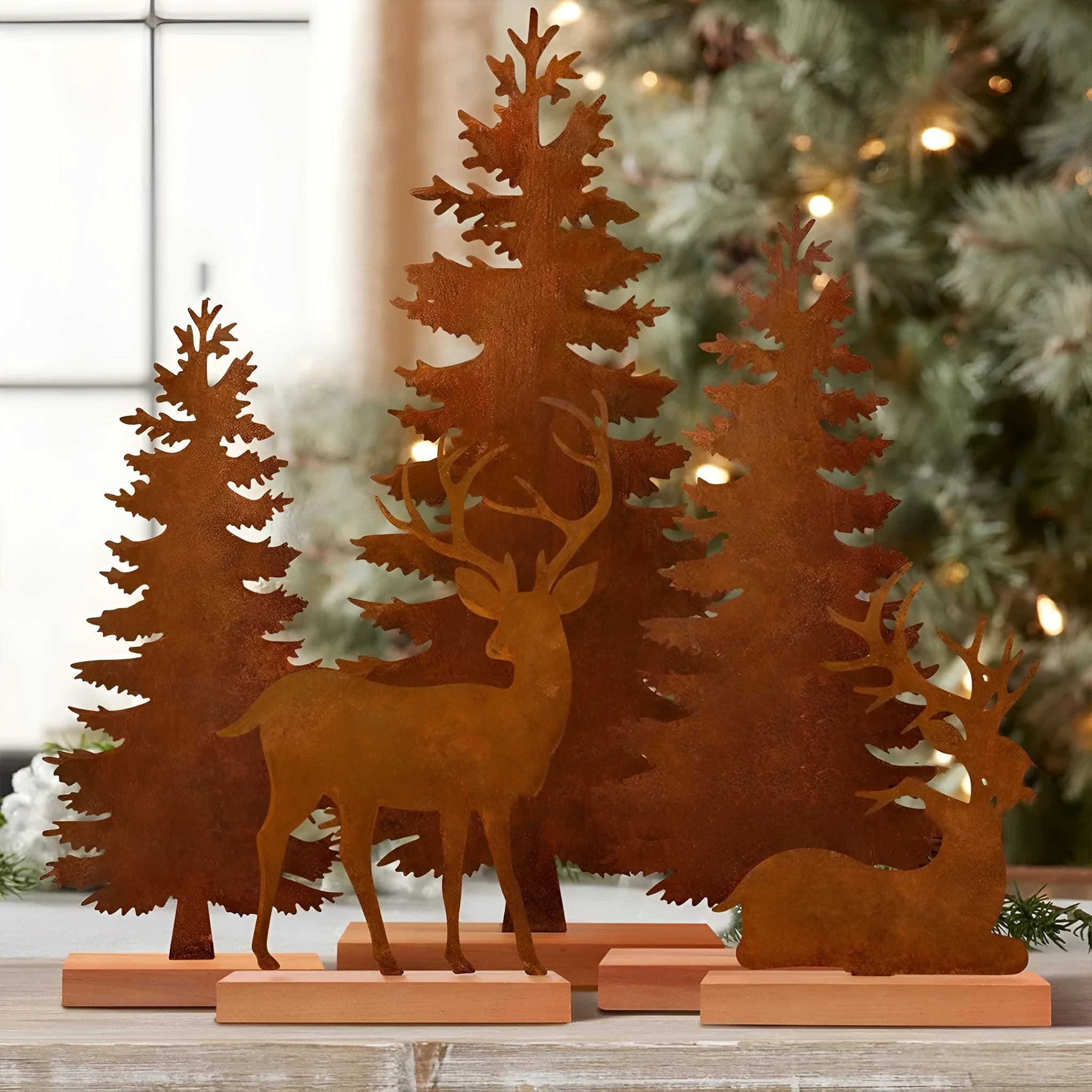 Three rustic iron metal Christmas tree ornaments featuring elk silhouettes, American style.
