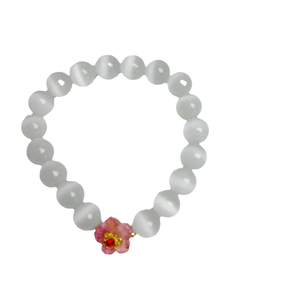 Handmade glass beaded bracelet with floral design in yellow, pink, white, or green colour options.