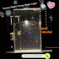 DIY snowy night light kit showing a small assembled street lamp with LED lights on a snowy flowing water landscape