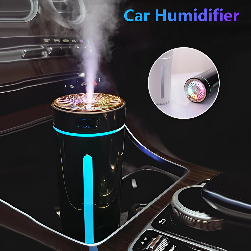 Compact black wireless USB humidifier with colourful LED lights on a car cup holder.