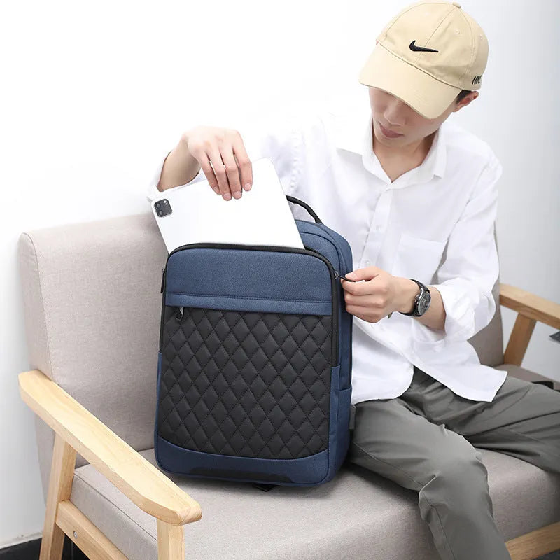 Men's Oxford cloth travel backpack in black showing curved shoulder strap and diamond mesh back panel