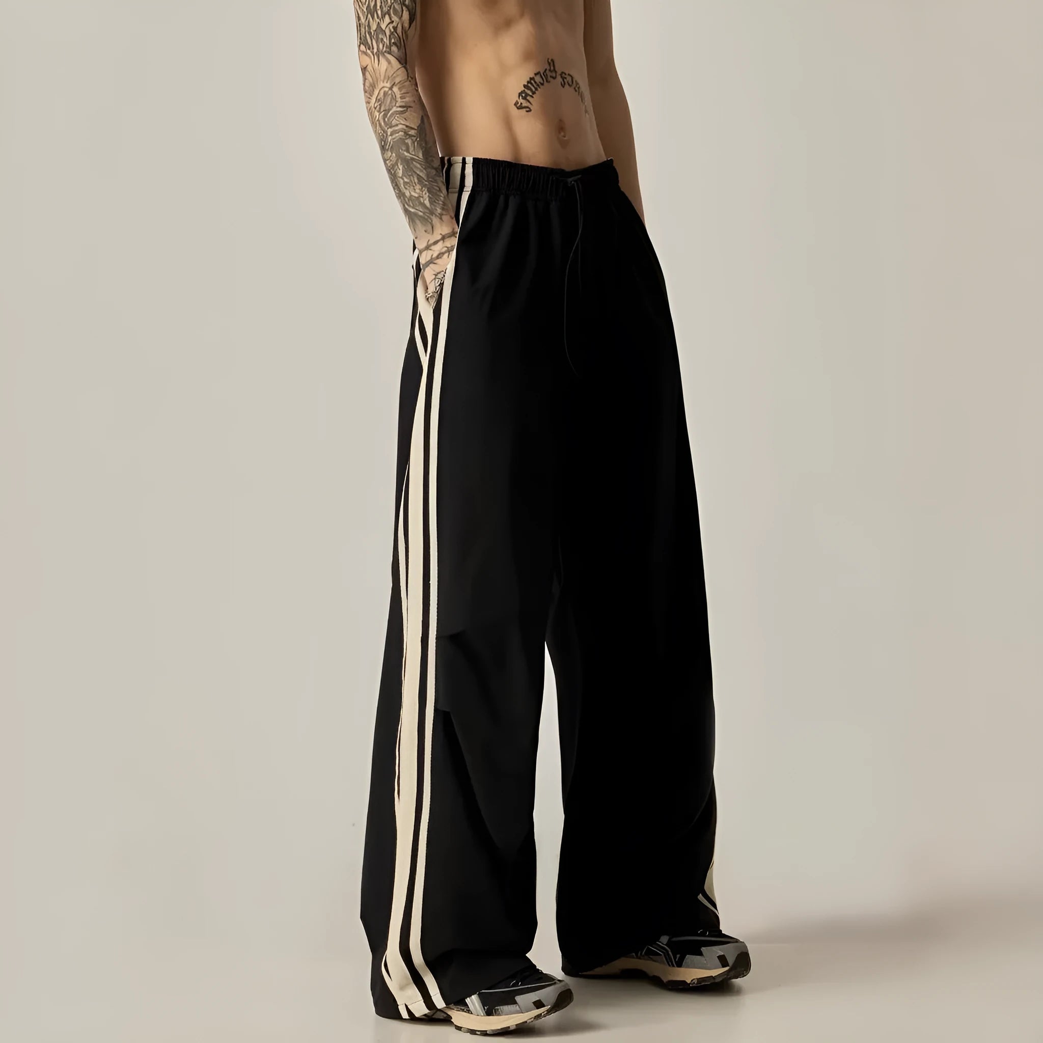 Black wide leg climbing pants for men showing high waist and straight leg design