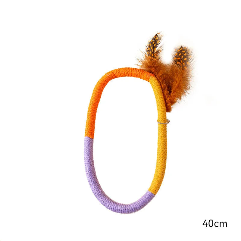 Green circular cotton rope cat toy with feathers and catnip for interactive play