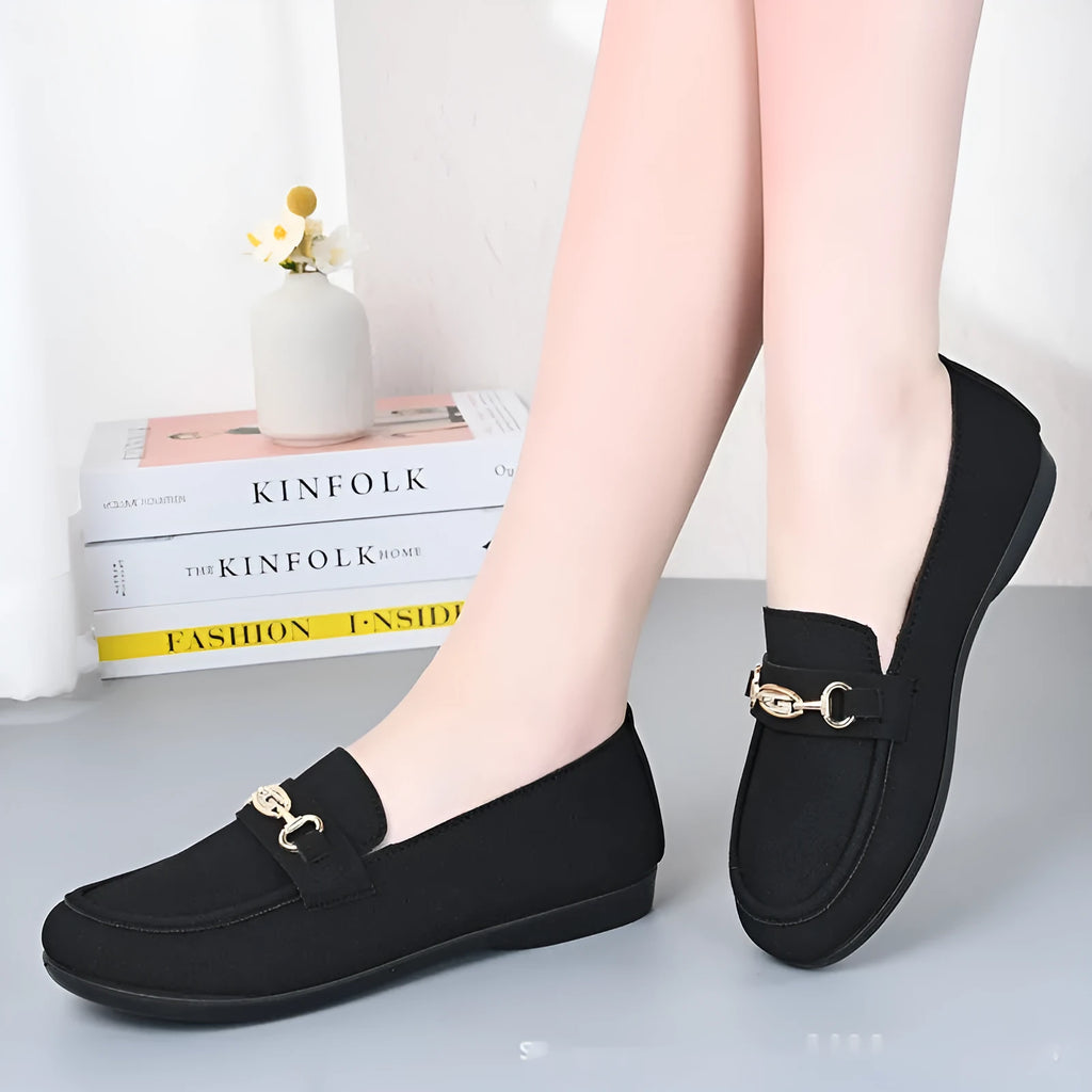Gommino women's black casual slip-on shoes with round toe and flat rubber sole on a white background.