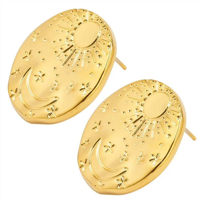 A pair of geometric shell pattern stud earrings in a gold finish on a plain background.