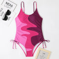 Blue sleeveless backless one-piece swimsuit for women on a mannequin, showing the tight-fitting striped design.