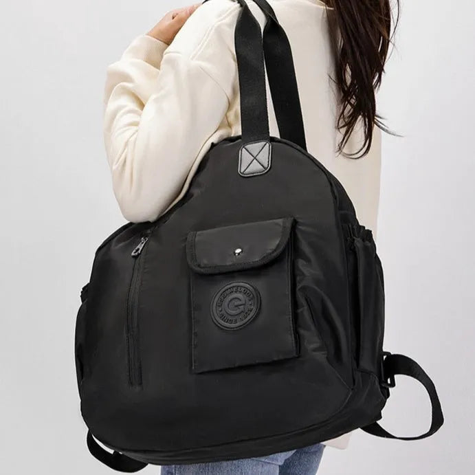 Large lightweight nylon backpack in khaki colour showing front sandwich pockets.