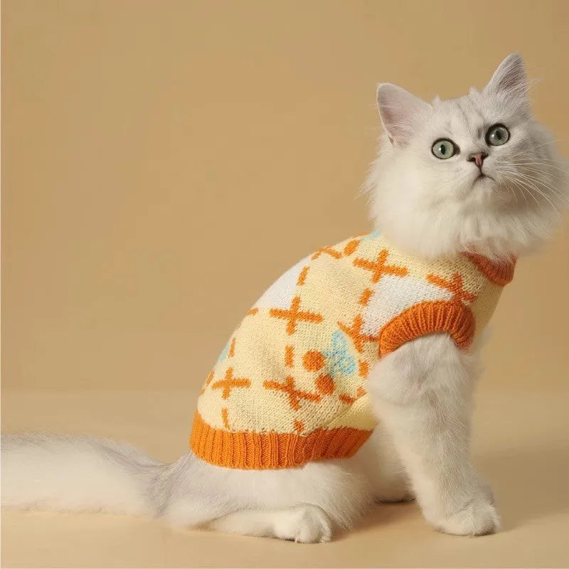 Orange cherry coloured thick knit cat sweater for autumn and winter, shown on a cat.