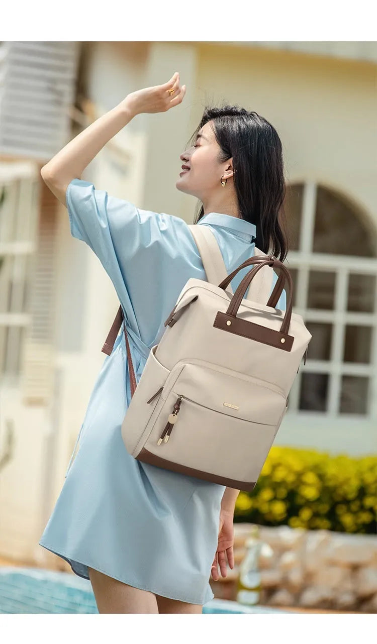 Large fabric backpack for women with synthetic leather trim, shown in apricot colour with adjustable straps.