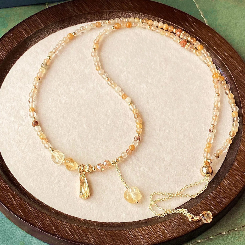 Women's natural citrine bracelet with three interconnected circles in caramel gold colour featuring Saturn design elements