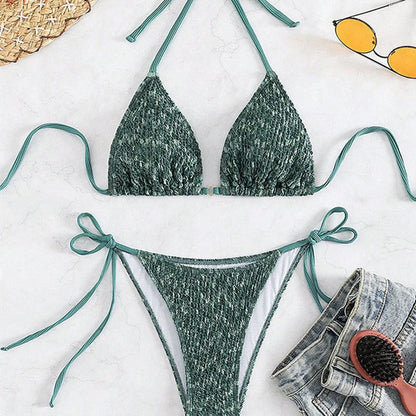 Green backless halter swimsuit with adjustable straps and matching shorts on mannequin