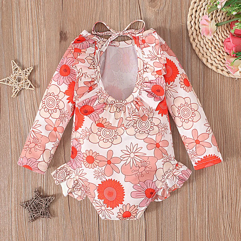 Girl's floral print swimsuit with crew neckline and open back design in orange colour