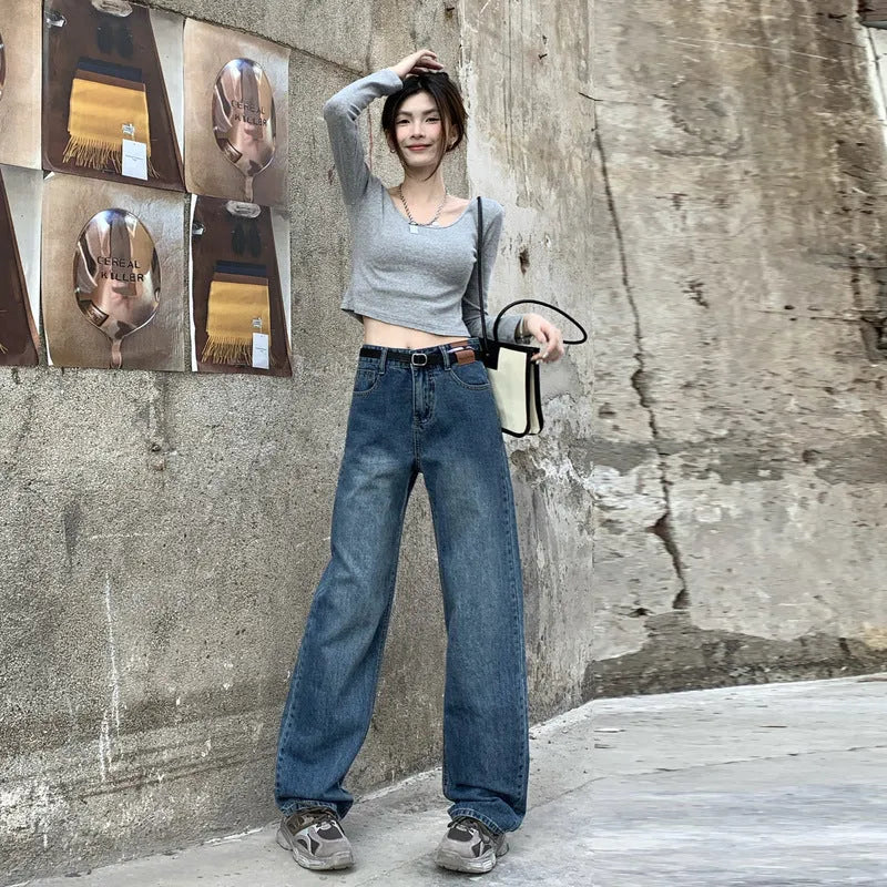Women's retro blue high waist straight leg jeans laid flat, showing the five-pocket design and button fly.