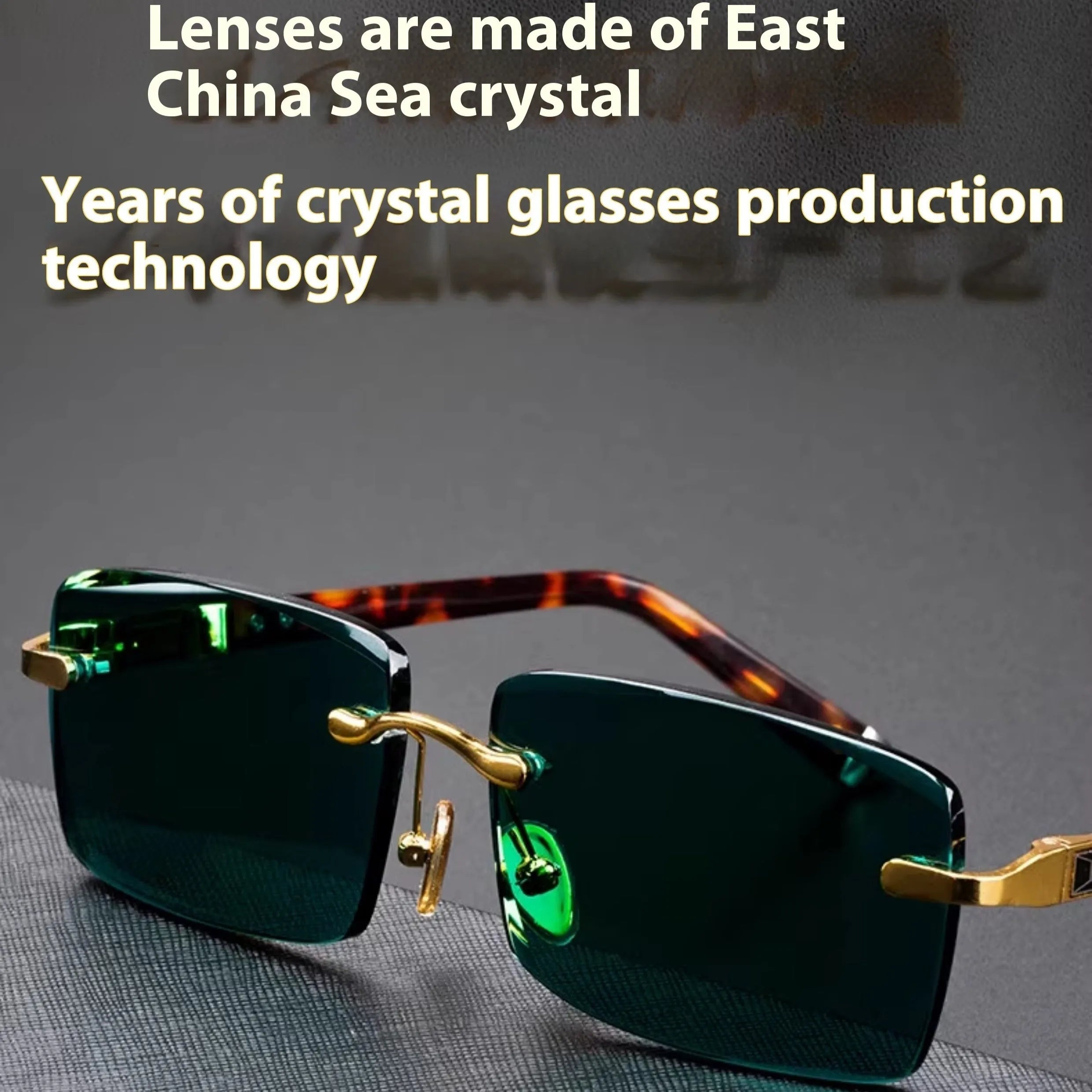 Dark green crystal frameless sunglasses with a case and cleaning cloth on a table.