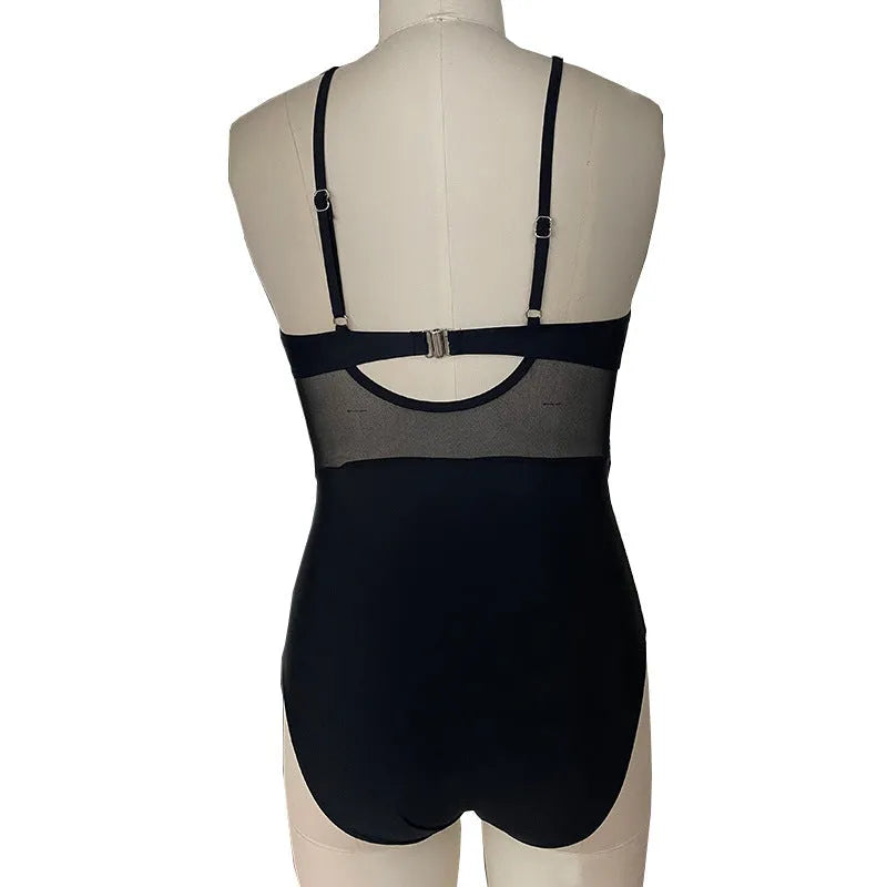 Women's mesh spliced backless one-piece swimsuit in solid black colour, polyester lined