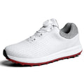 Men's low-top white golf sneakers with breathable hollow-out sole on grass.