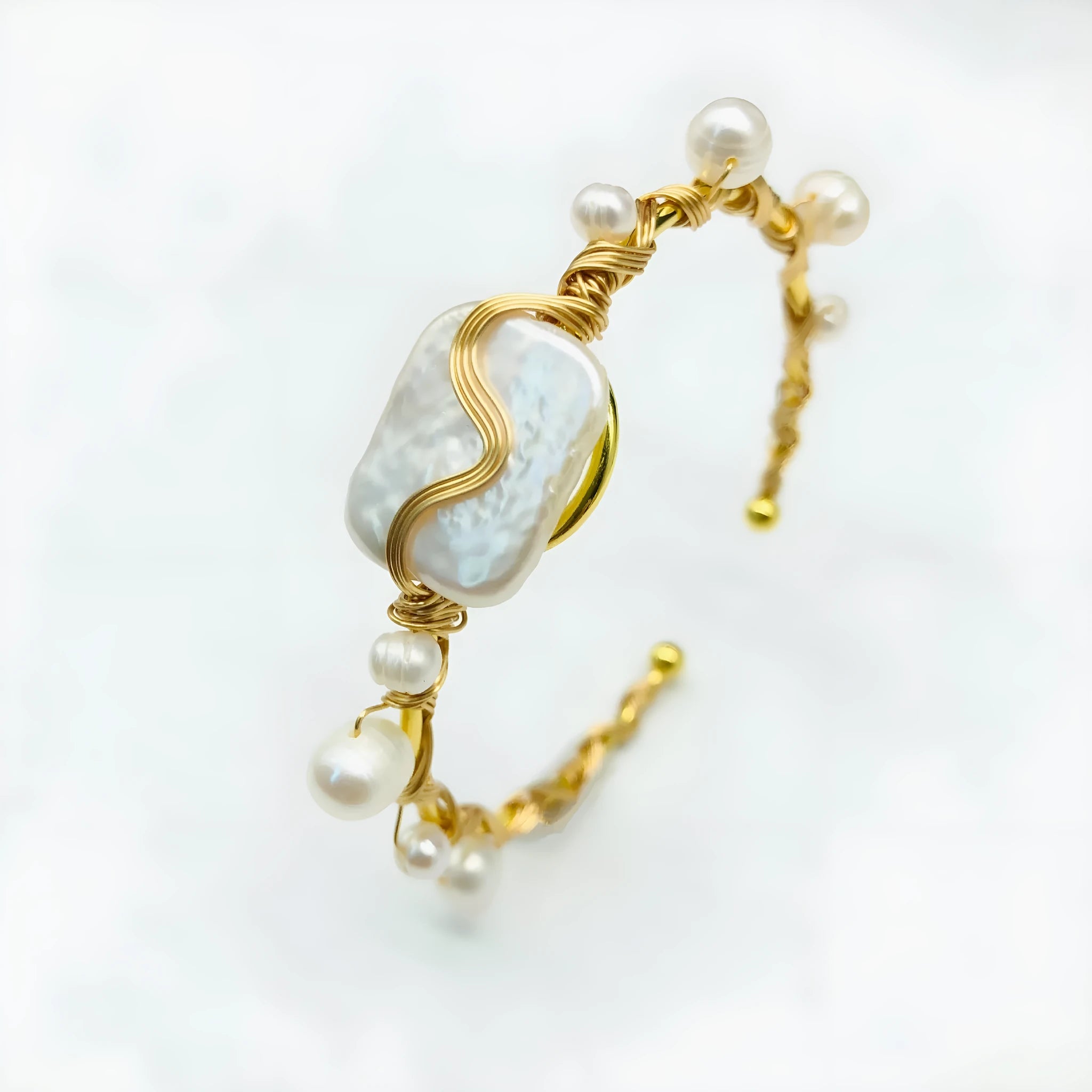 Natural freshwater pearl bracelet with gold titanium steel wire-wrap on hand model