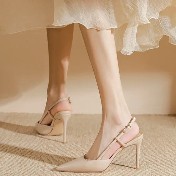 Apricot coloured women's high-heeled sandals with a single strap and buckle on a rubber sole.