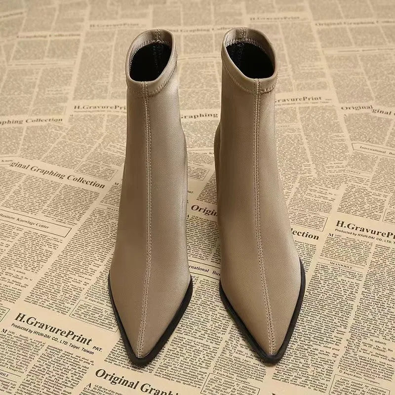 Women's khaki pointed-toe ankle boots with a wedge heel on a rubber sole.