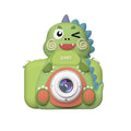 Children's mini cartoon camera with silicone body, Big Head Dinosaur colour, with lanyard and charging cable on white background