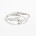 Metal alloy opening bracelet in matte or glossy finish with ellipse design element cold wind style