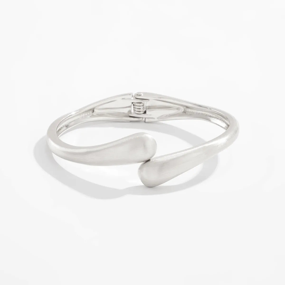 Metal alloy opening bracelet in matte or glossy finish with ellipse design element cold wind style
