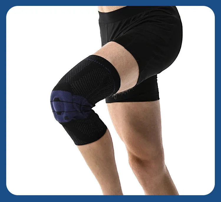 A pair of adult sports knee pads in a black and blue colourway, shown on a knee for scale.