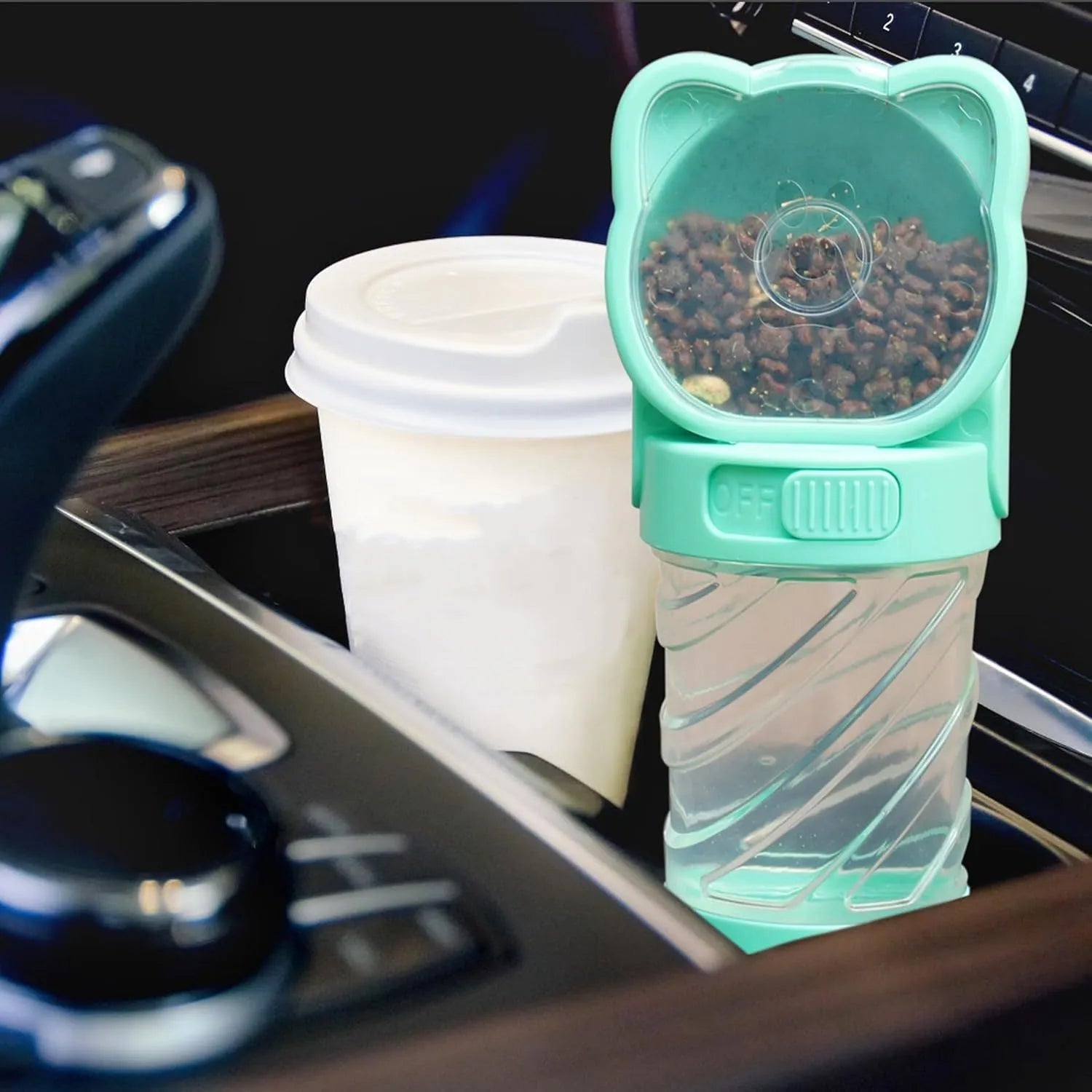 Green, pink, or white 3-in-1 portable pet water bottle with food container and garbage bag dispenser and shoulder strap.
