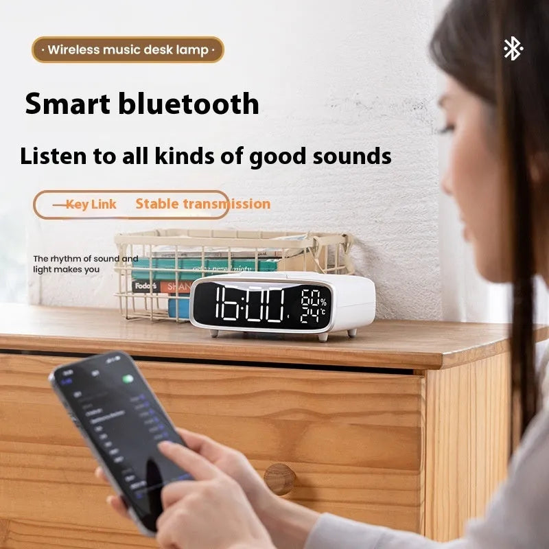 White round Bluetooth speaker wireless charger with night light function on bedside table