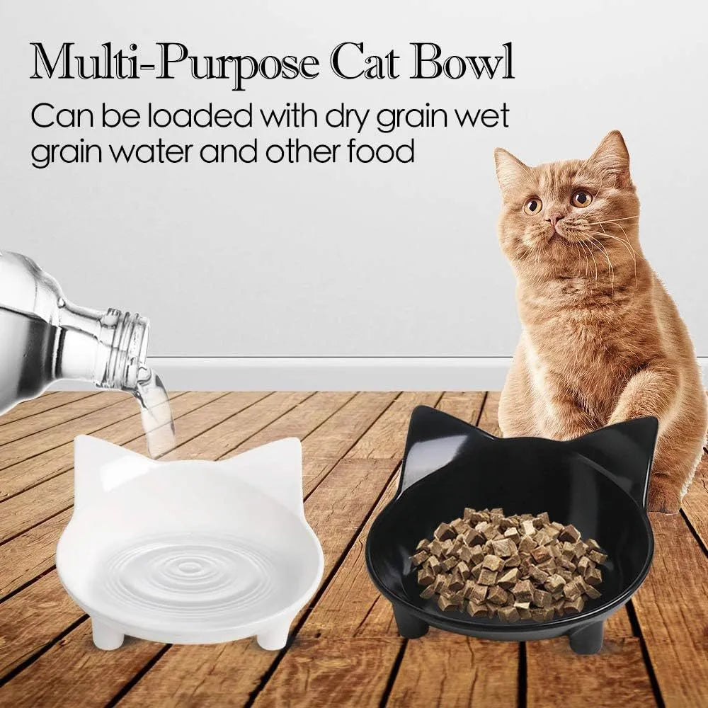 Black shallow cat food bowl with non-slip rubber base on kitchen floor