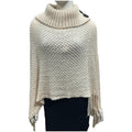 Sleeveless dot pattern knit cloak poncho in apricot colour, laid flat.
