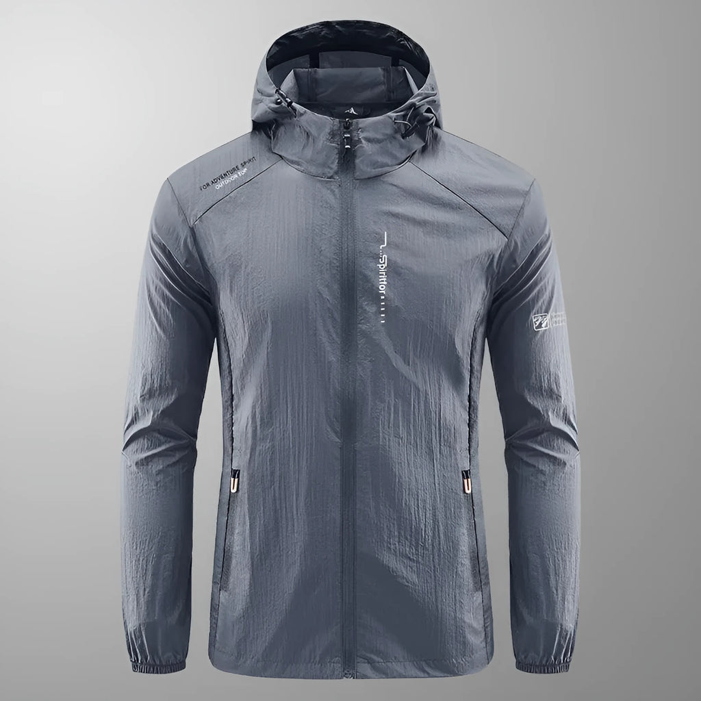 Man wearing a lightweight grey hooded nylon jacket for summer sun protection